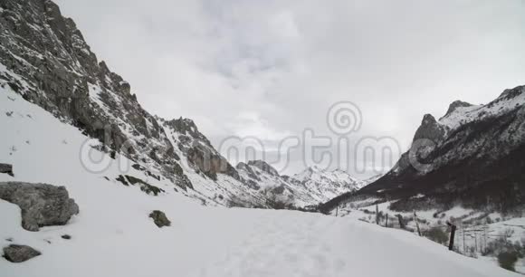 右侧有一片森林环绕着群山的雪谷视频的预览图