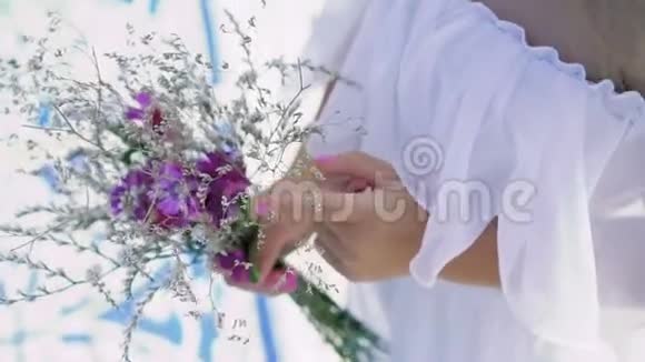 一个聪明温柔的小女孩手中的野花的花束慢慢地视频的预览图