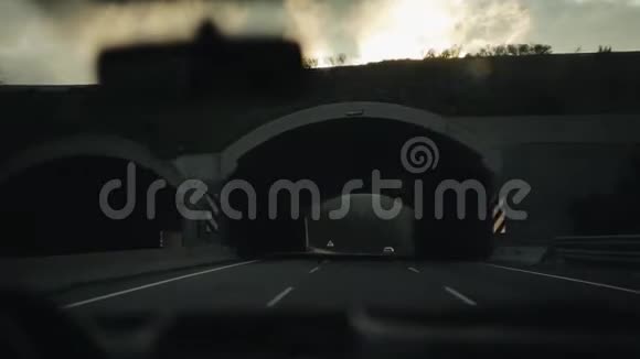 在桥下开车在一条山道上出去景色很美乌云密布太阳出来了视图视频的预览图