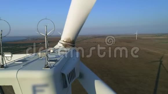 关闭风力涡轮机高空俯视风力涡轮机位于白色现代风力涡轮机建筑之上视频的预览图