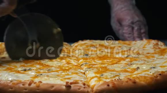 厨师在白色手套的特写切美味的四个奶酪比萨饼在木板上的桌子上框架传统视频的预览图