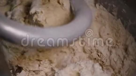 生产搅拌机中揉面面团的特写库存录像螺旋捏合机揉捏新鲜面团用于烘焙视频的预览图