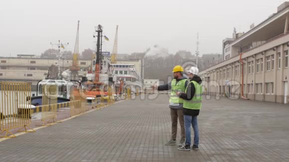 港口工人戴着头盔在看文件海运视频的预览图