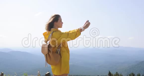 女士在山上拍照智能手机拍照风景优美自然背景欣赏风景视频的预览图