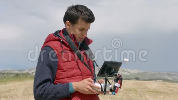 一个用遥控器拍摄空中视频的人用无人机安装的摄像机机器人视频的预览图