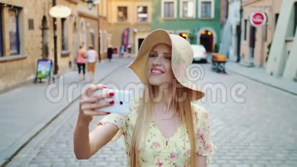 女人观光和拍照开朗的女人观光和拍摄老镇街视频的预览图