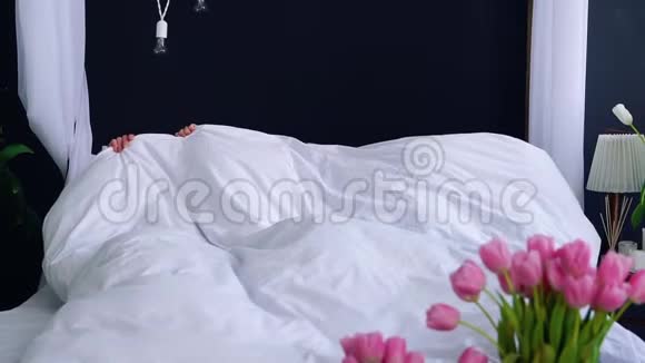 一群漂亮的女孩早上醒来穿着睡衣在一张床上举行单身派对在床上啜饮微笑视频的预览图