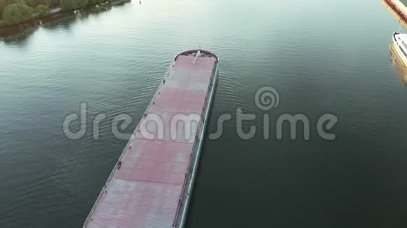 夏季阳光明媚的日子里没有货物的空驳船在河边漂浮视频的预览图