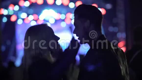 微笑的情侣在音乐会上跳舞聊天人们在俱乐部欣赏音乐视频的预览图