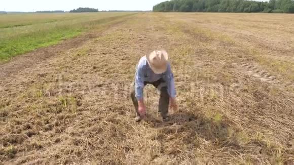农夫在田间地头上捡稻草检查收割机后的产量损失视频的预览图