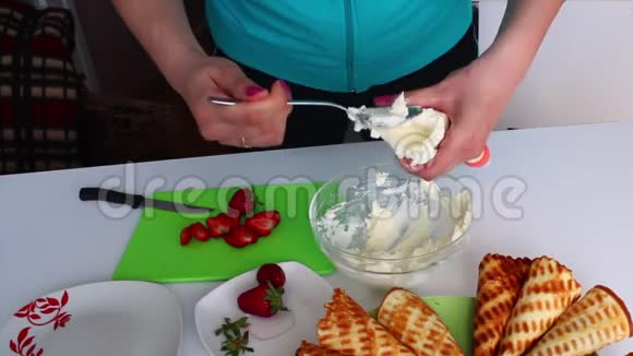 女人把奶油放进糖果的袋子里视频的预览图