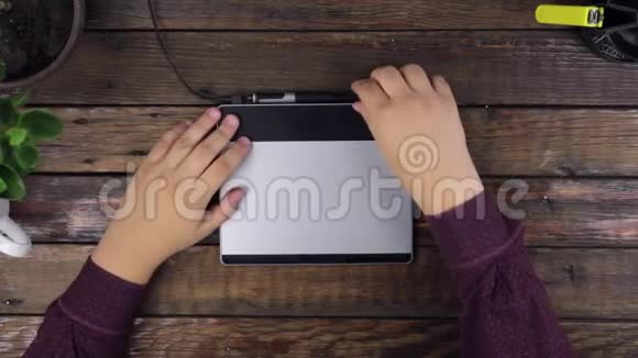 俯视图一个正在绘制平板电脑的人的手视频的预览图