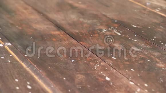 特写镜头拍摄雨落到老木板台面视频的预览图