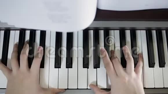 少女在数字钢琴的键盘上弹奏特写视频的预览图
