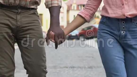 幸福的夫妻牵着手漫步在城市年轻而无忧无虑的人们视频的预览图