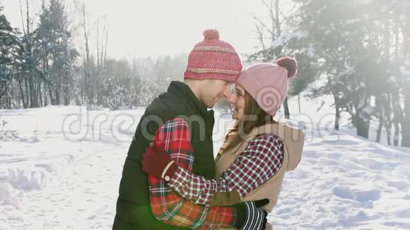 男人和女孩在冬天的公园里摸着头晴天的雪慢的莫视频的预览图