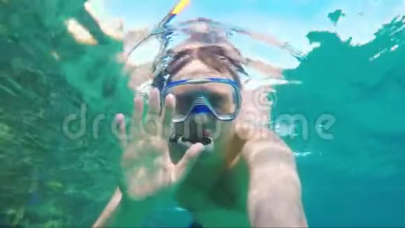 潜水员自拍挥舞着相机水下视频视频的预览图