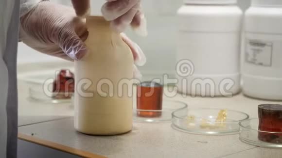 研究员准备在实验室进行化学实验戴手套的实验室工作人员打开瓶子视频的预览图