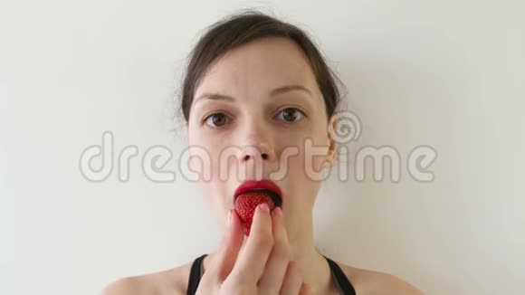 女人吃草莓的肖像前景视频的预览图