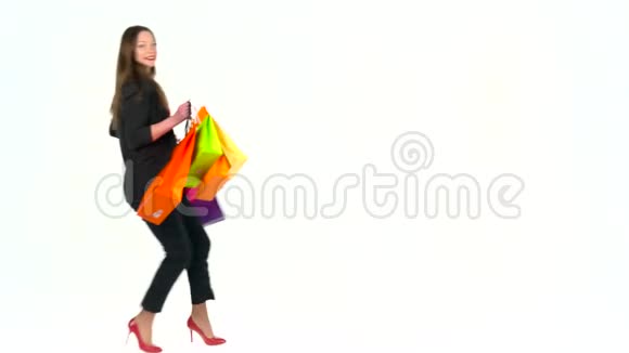 女购物者拿着白色背景的五彩购物袋在工作室让去购物吧视频的预览图
