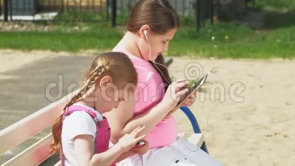 在户外使用移动设备的学龄前少女视频的预览图