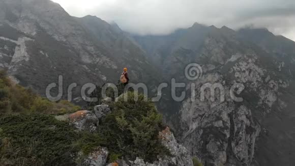 女摄影师戴着一顶帽子带着相机在山上散步北高加索地区视频的预览图