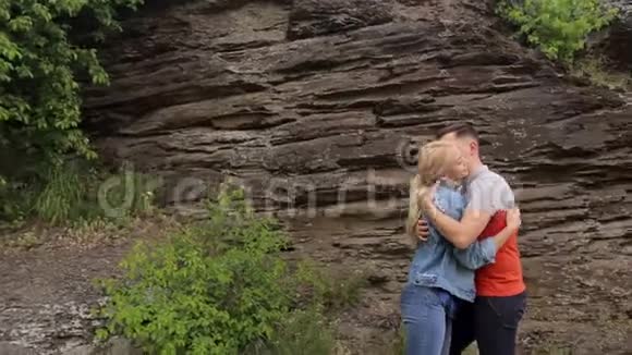 一对夫妇在岩石的背景下拥抱视频的预览图