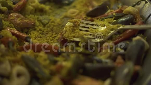 用贻贝虾菖蒲和辣椒在平底锅中配制海鲜饭把煮好的西班牙海鲜饭和红色的视频的预览图