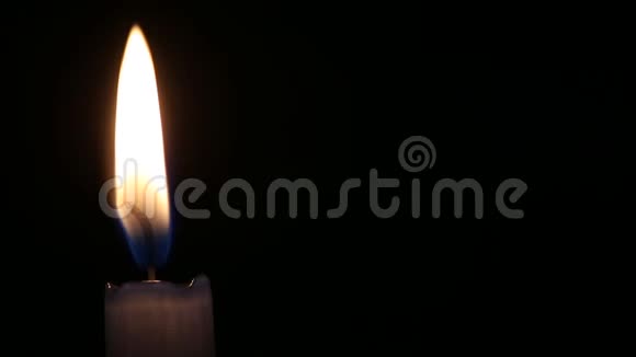黑色背景下蓝色蜡烛的平静火焰一个方便的地方视频的预览图