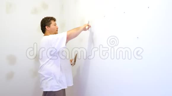 油漆工人用油漆抹刀把墙贴好视频的预览图