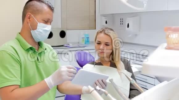 牙科医生用数码片解释牙齿治疗的4k镜头视频的预览图