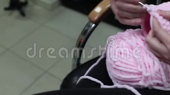 女性用粉红色的纱线编织手工制作针织品视频的预览图