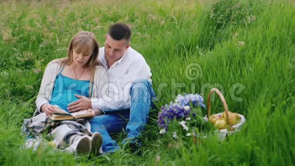 父母在等孩子他们一起在野餐时读了一本书视频的预览图