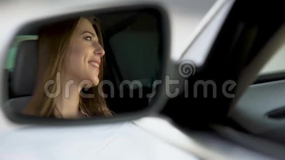 快乐女司机坐在车里和男朋友聊天后视镜视频的预览图