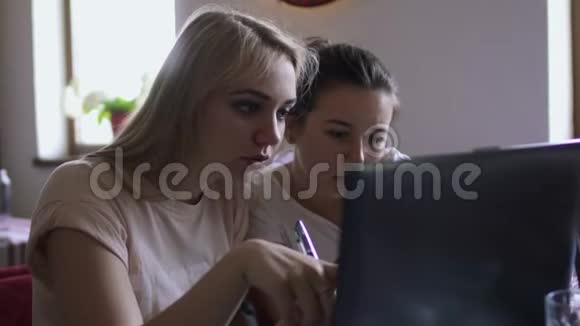 两个女孩用笔记本电脑讨论视频的预览图