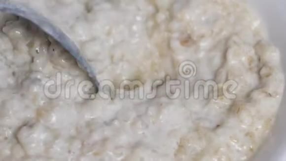 烹饪燕麦片用勺子搅拌燕麦片特写早餐视频的预览图
