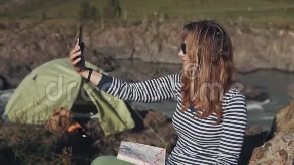 女游客在山区旅行时通过视频交流与朋友交谈视频的预览图