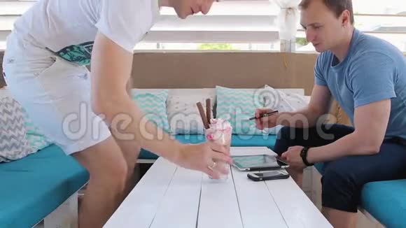 男人在咖啡馆聊天用平板电脑工作视频的预览图