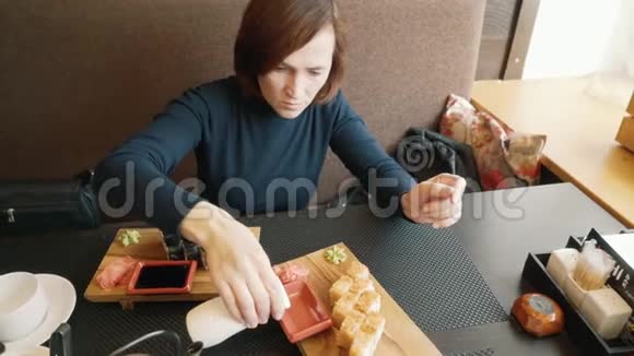 女人在吃寿司一个女人正在倒酱油视频的预览图