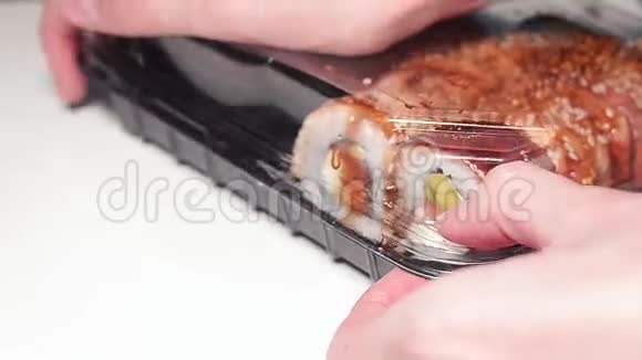 女人用新鲜的日本寿司关上一个塑料盒子视频的预览图