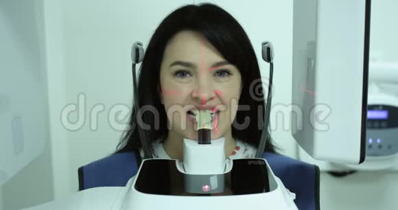 一位牙医在屏幕上显示一张x光并向病人解释正畸医生告诉病人智慧视频的预览图