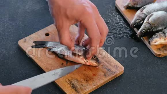 一个挖鲤鱼的人煮鱼双手特写视频的预览图