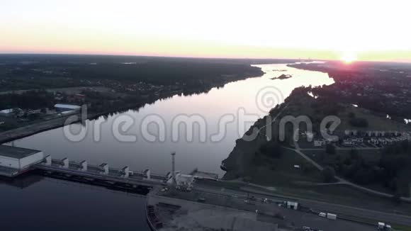 傍晚日落时分飞越里加道加瓦河上的水电站视频的预览图