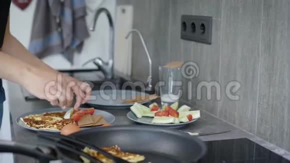 一个女人正在盘子里放早餐奥梅莱特蔬菜和减肥面包视频的预览图