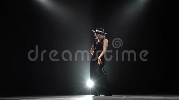 女孩跳西班牙语燃烧舞黑色背景从后面发光慢动作视频的预览图