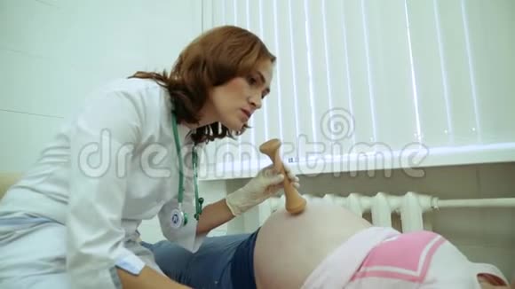 医生用听诊器倾听怀孕的女孩视频的预览图