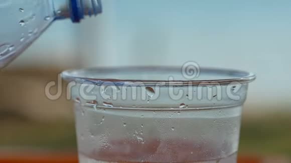 男人们在玻璃杯里倒水然后喝酒自然和模糊的背景视频的预览图