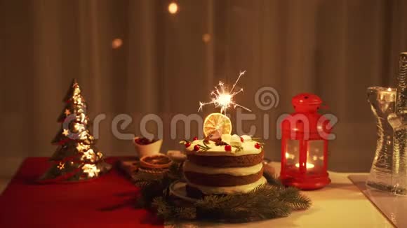 圣诞节那天晚上年轻女子在蛋糕里点了一个火花视频的预览图