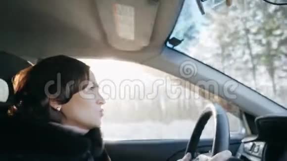 一个穿着黑色皮毛大衣的女人正在开车女孩开车视频的预览图