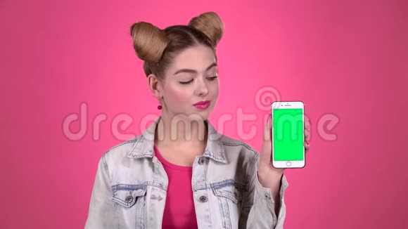 手里拿着手机和纸笔的青少年粉色背景视频的预览图